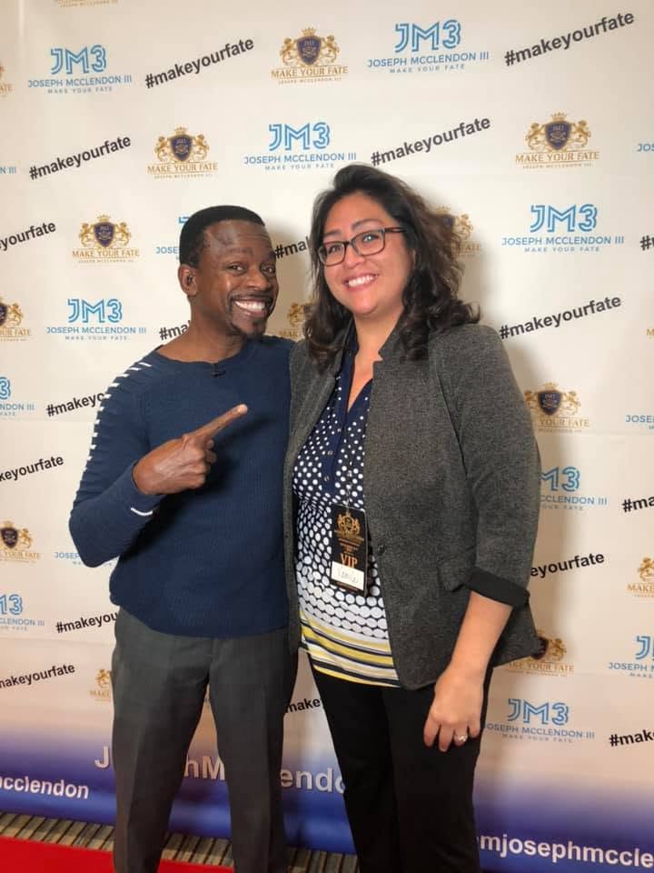 Yaya with keynote speaker Joseph McClendon III at a speaker event.