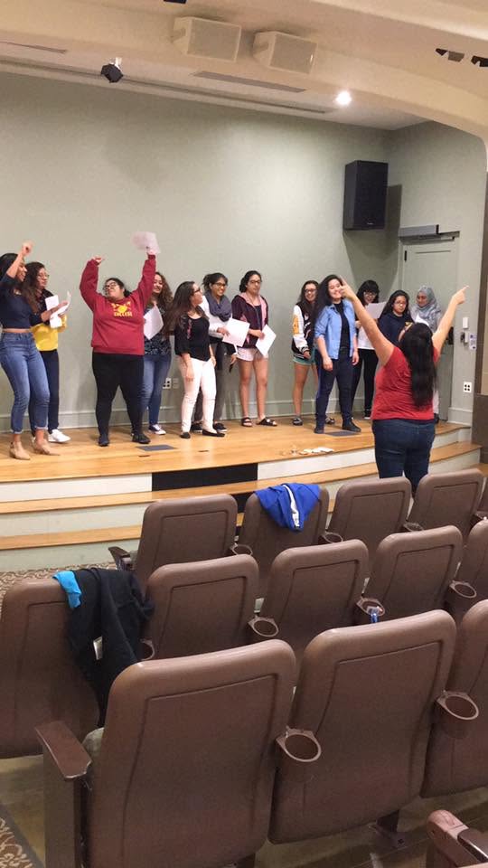 Salem College students cheering during an interactive moment in the experience.