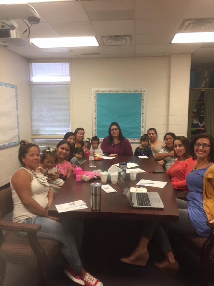 Yaya leading a parent engagement meeting with families.