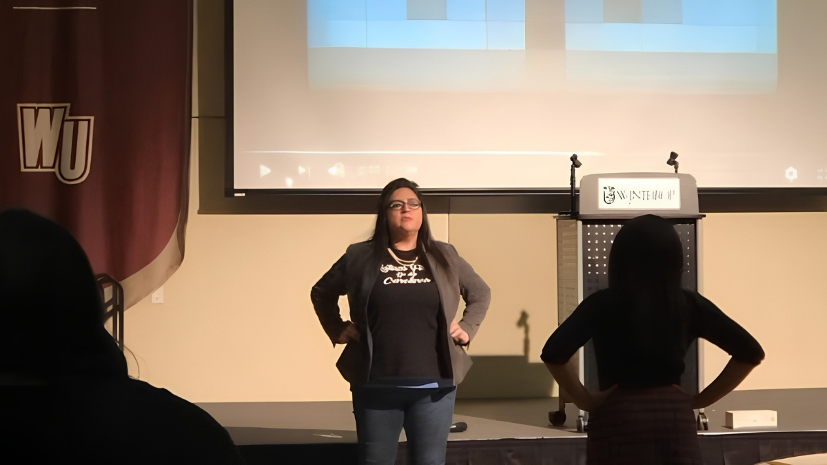 Yaya speaking on stage at Winthrop University.