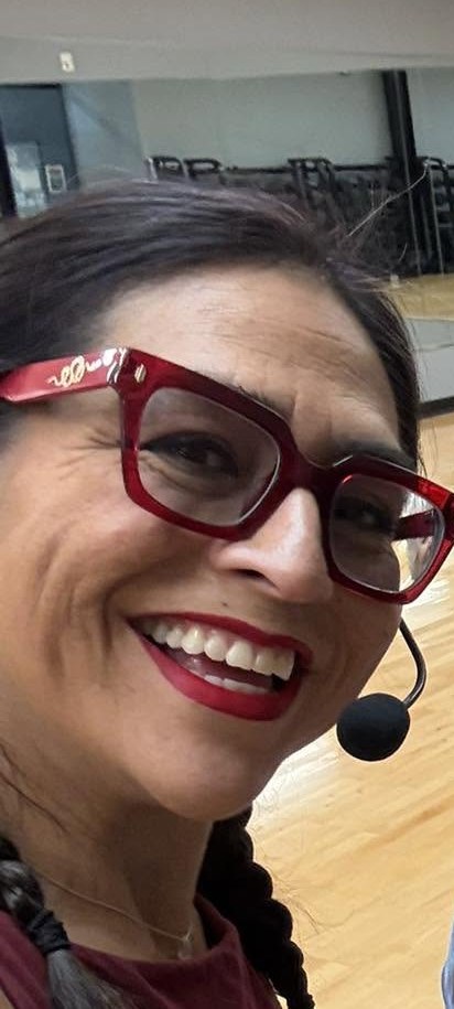 Yamile "Yaya" McBride wearing a headset microphone while leading a session.